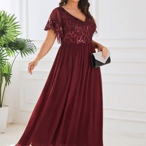 Beautiful burgundy evening dress with a V-neck and flutter sleeves. Sequin-embel